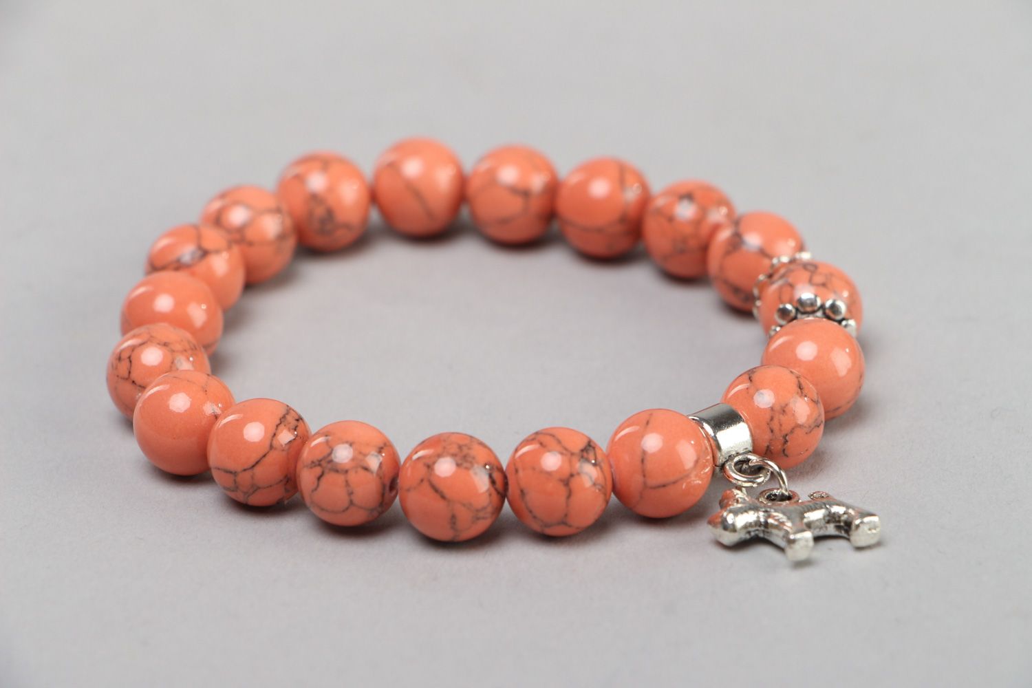 Cute handmade stretch wrist bracelet with natural coral beads and metal charm  photo 2