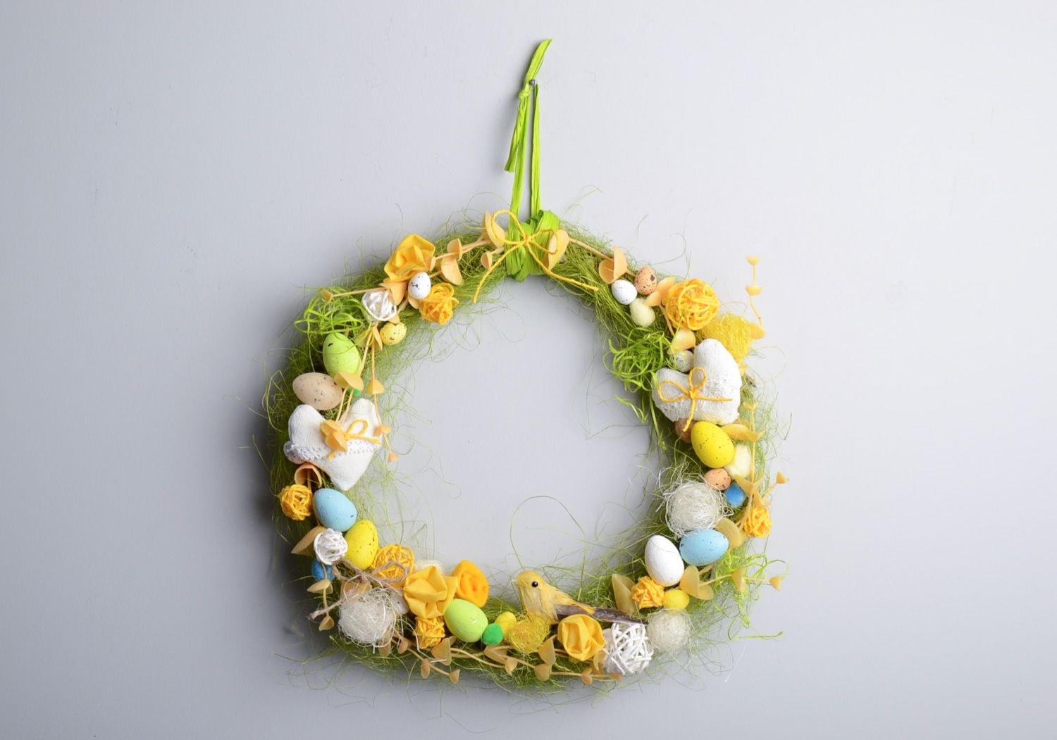 Handmade decorative Easter door wreath with little colorful eggs and feathers photo 1