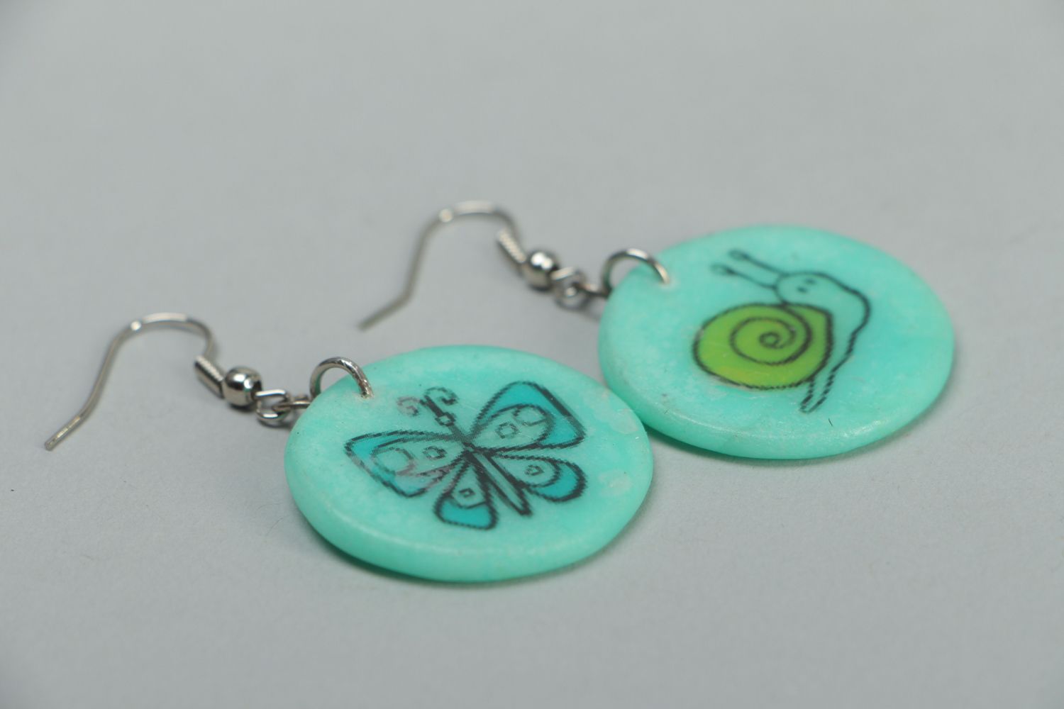 Turquoise plastic earrings with drawing photo 2