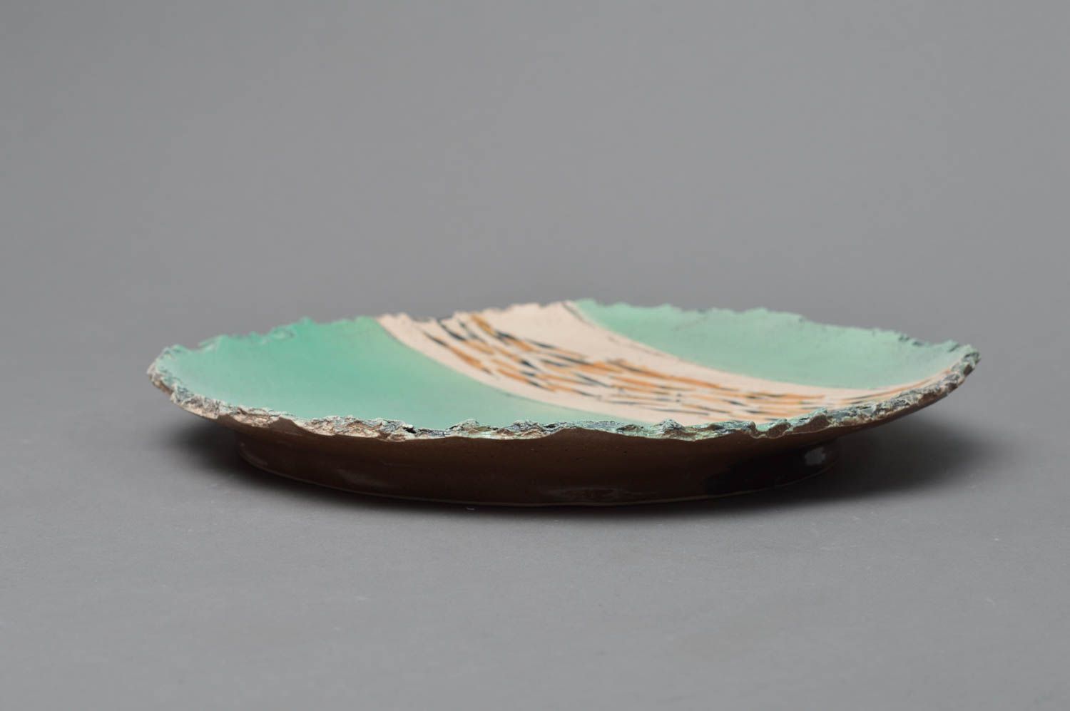 Handmade designer porcelain glazed plate with ragged edges of turquoise color photo 2