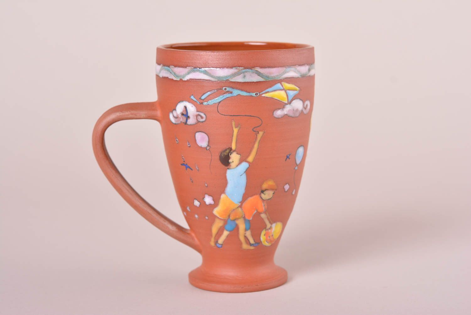 Tall red clay glazed 5 oz cup with boys' pattern and a handle photo 1