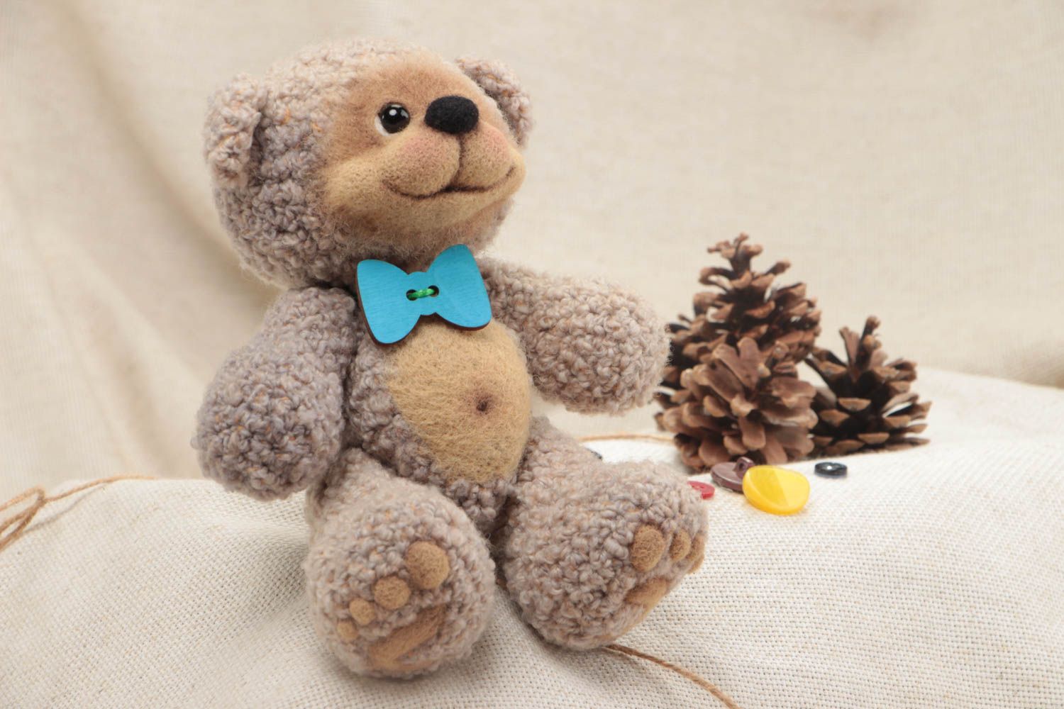 Handmade designer soft toy crocheted of wool and yarns beige bear with blue bow  photo 1