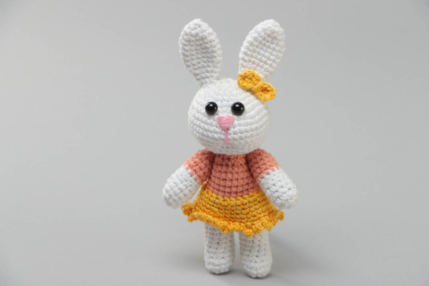 Handmade soft knitted white girl-rabbit toy in a dress for children photo 2