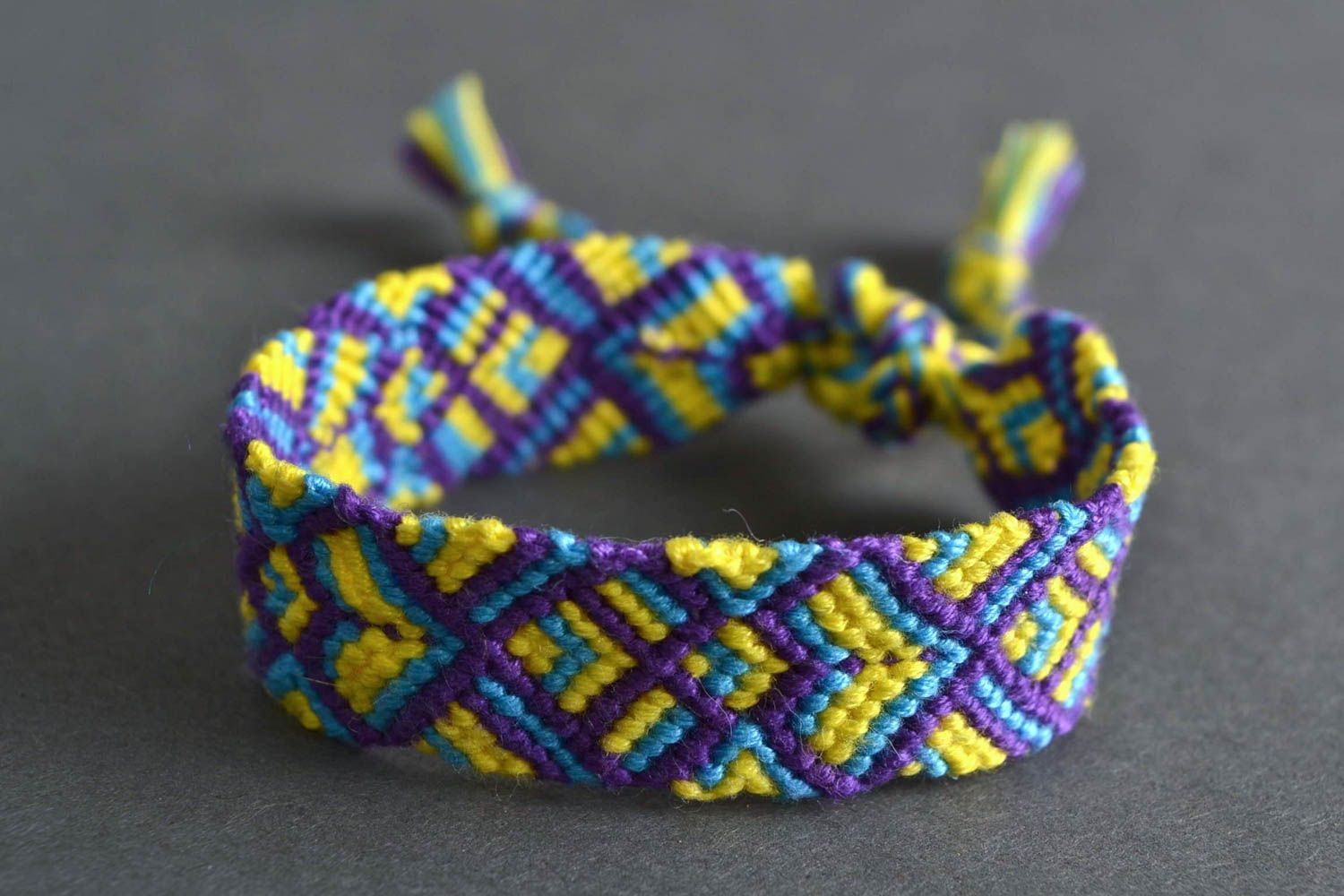 Gelb violettes handgemachtes geflochtenes Armband aus Fäden in Makramee Technik foto 1