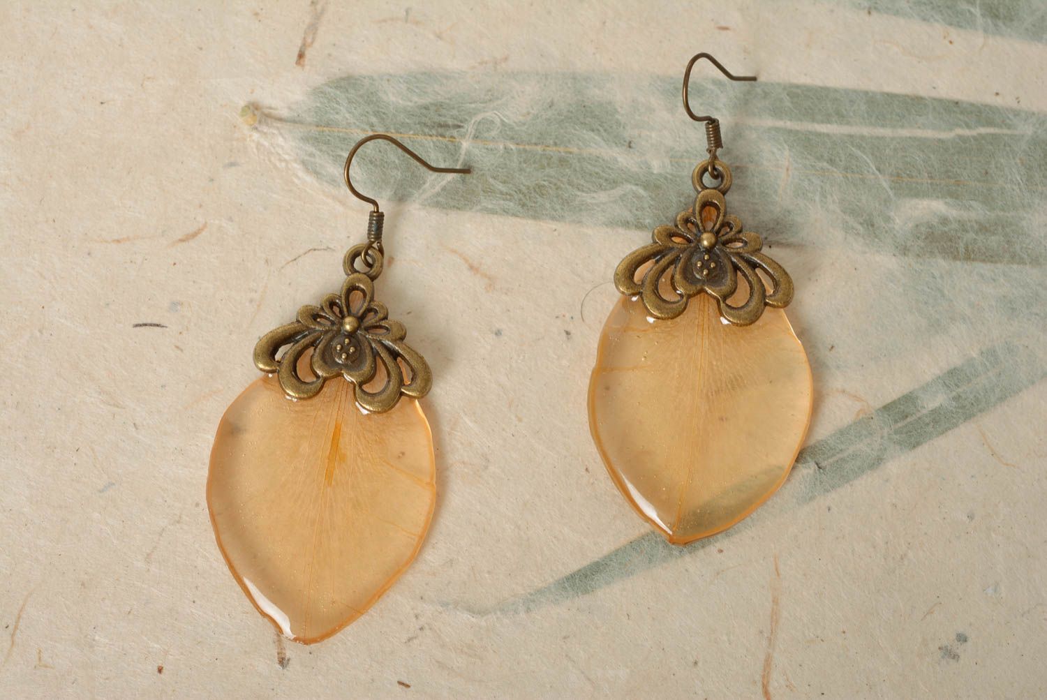 Handmade designer dangle earrings with transparent flower petal in epoxy resin photo 1