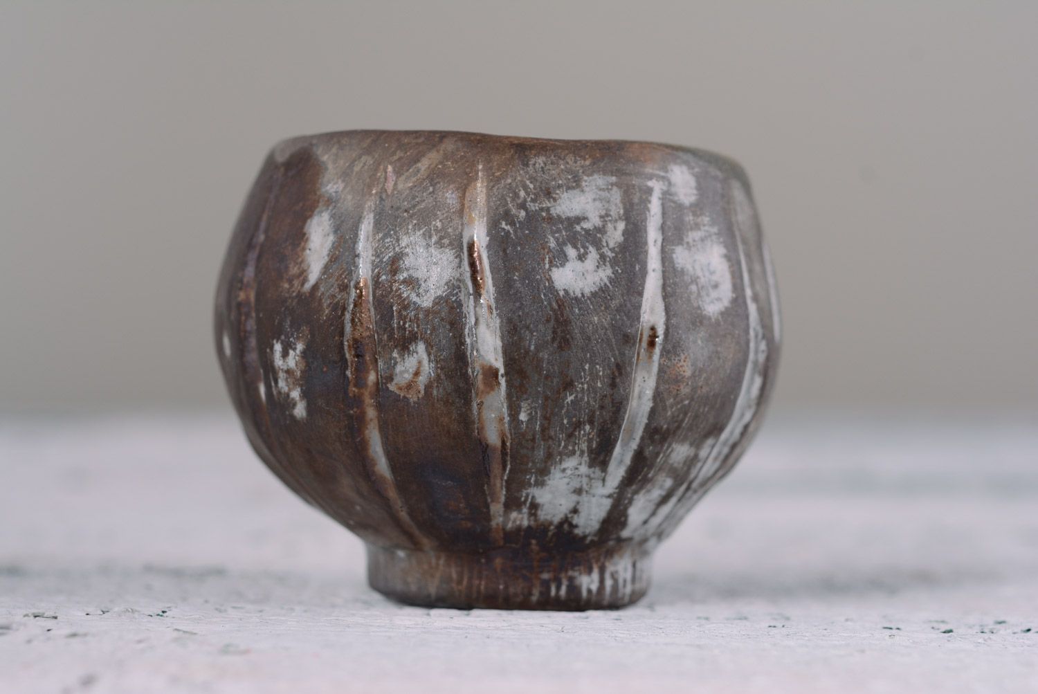Kilned clay cup without handles in dark brown colo with white insights photo 2