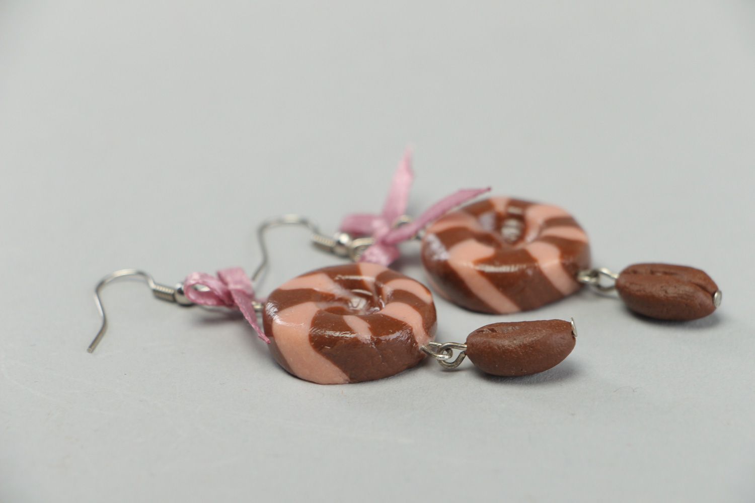 Handmade round dangle earrings made of plastic with satin bows in brown color photo 2