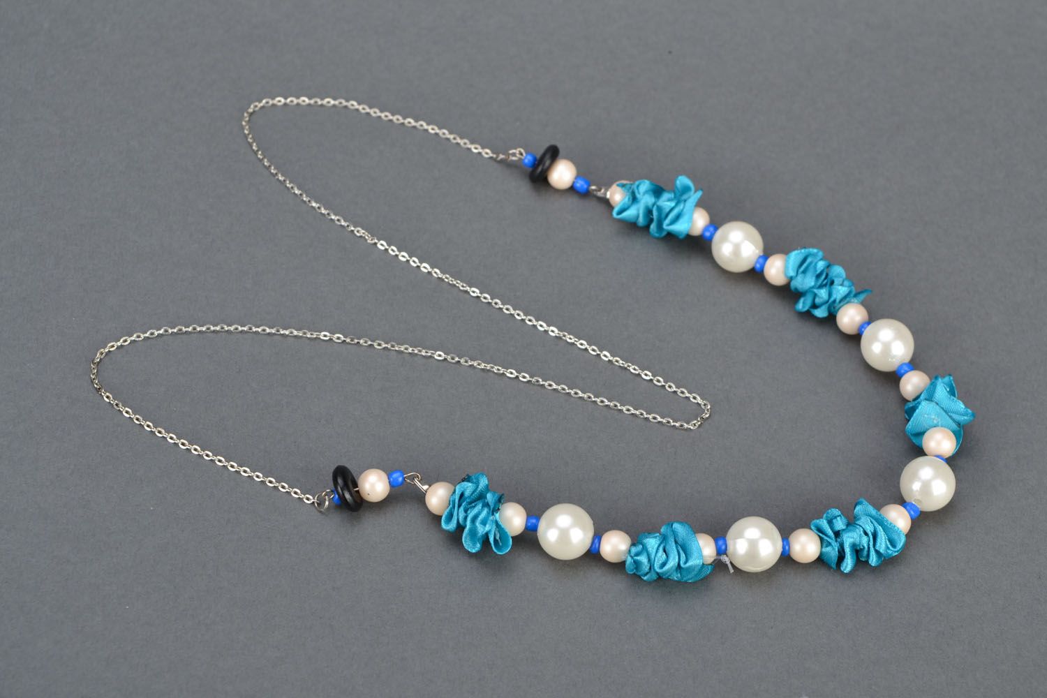 Beautiful necklace made of beads and satin photo 2