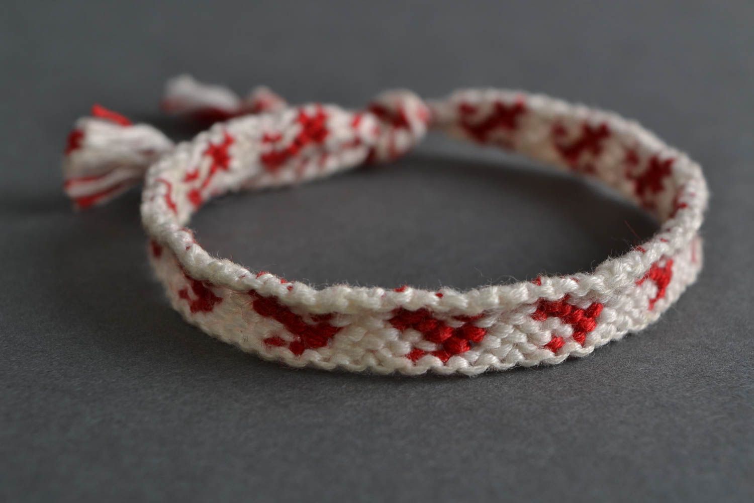 Handmade thin white and red friendship wrist bracelet woven of threads for girls photo 1