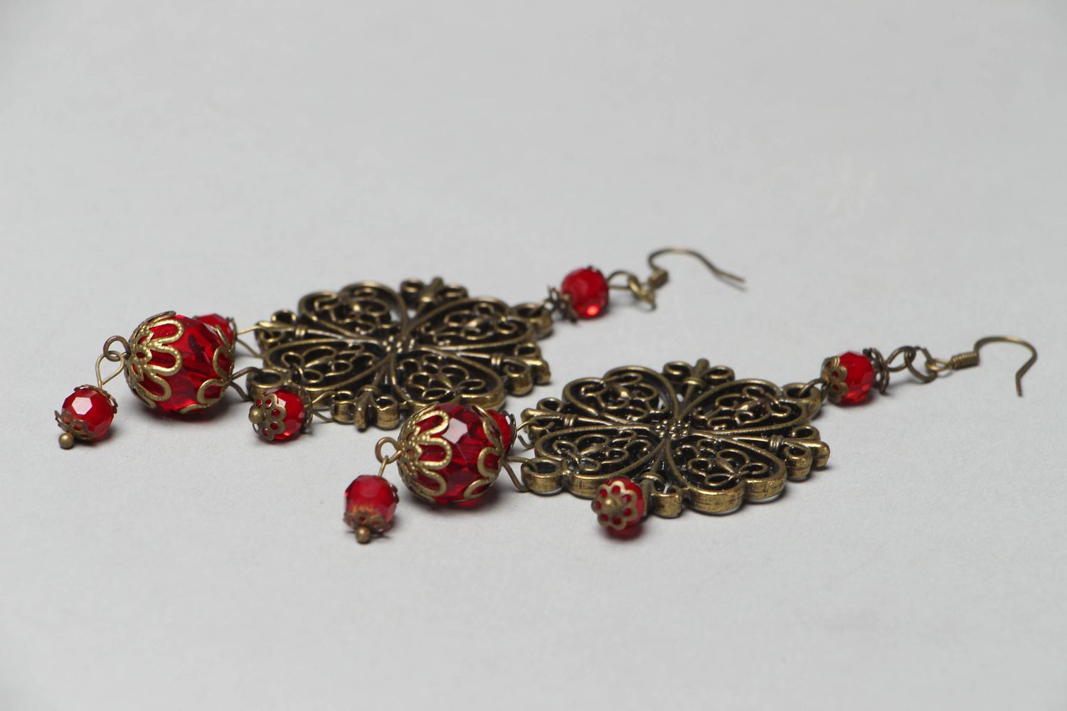 Metal earrings with glass beads of red color photo 2
