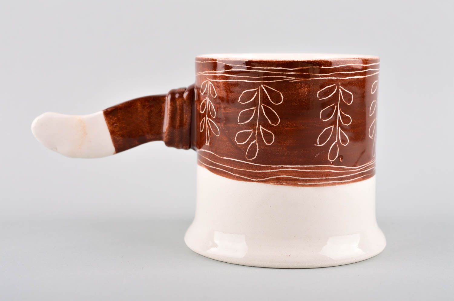 Teacup in white and brown cherry colors and non-standard handle in the shape of a stick photo 2