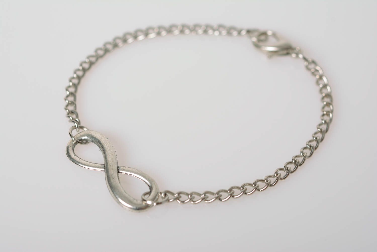 Handmade designer wrist bracelet with metal chain and infinity shaped insert photo 4