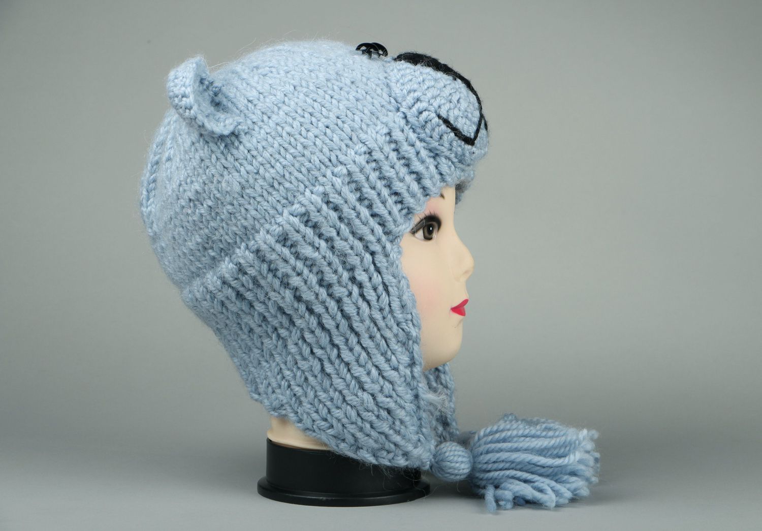 Knitted earflap hat made of semi-wool photo 1