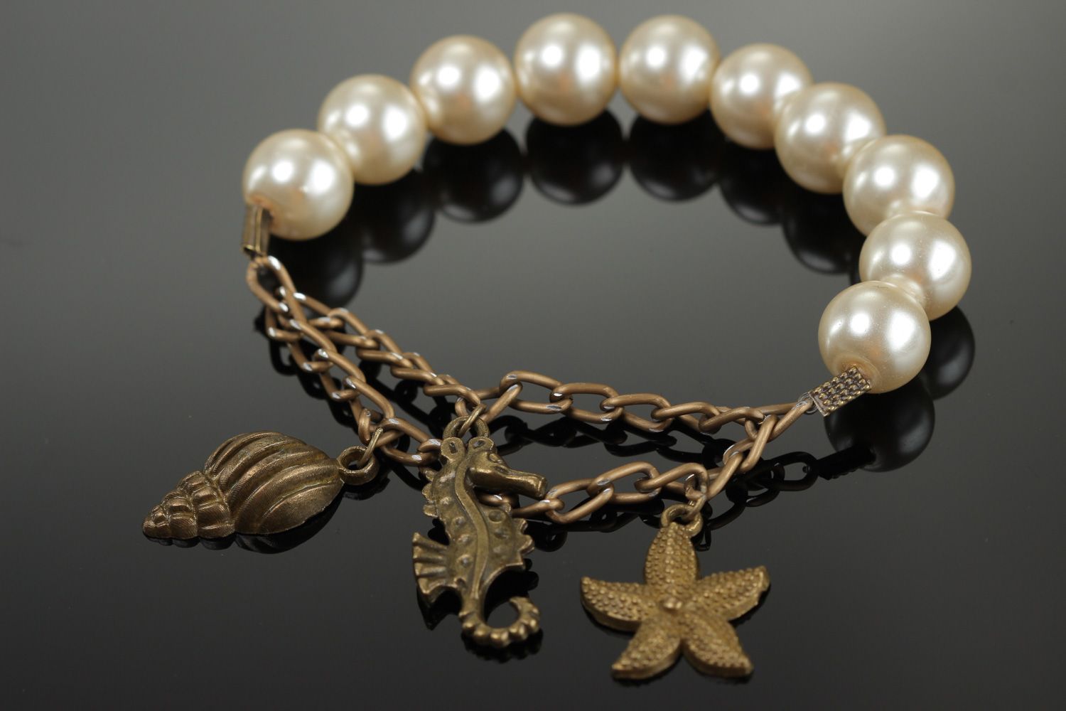 Elegant handmade bracelet with artificial pearls and metal charms for women photo 1