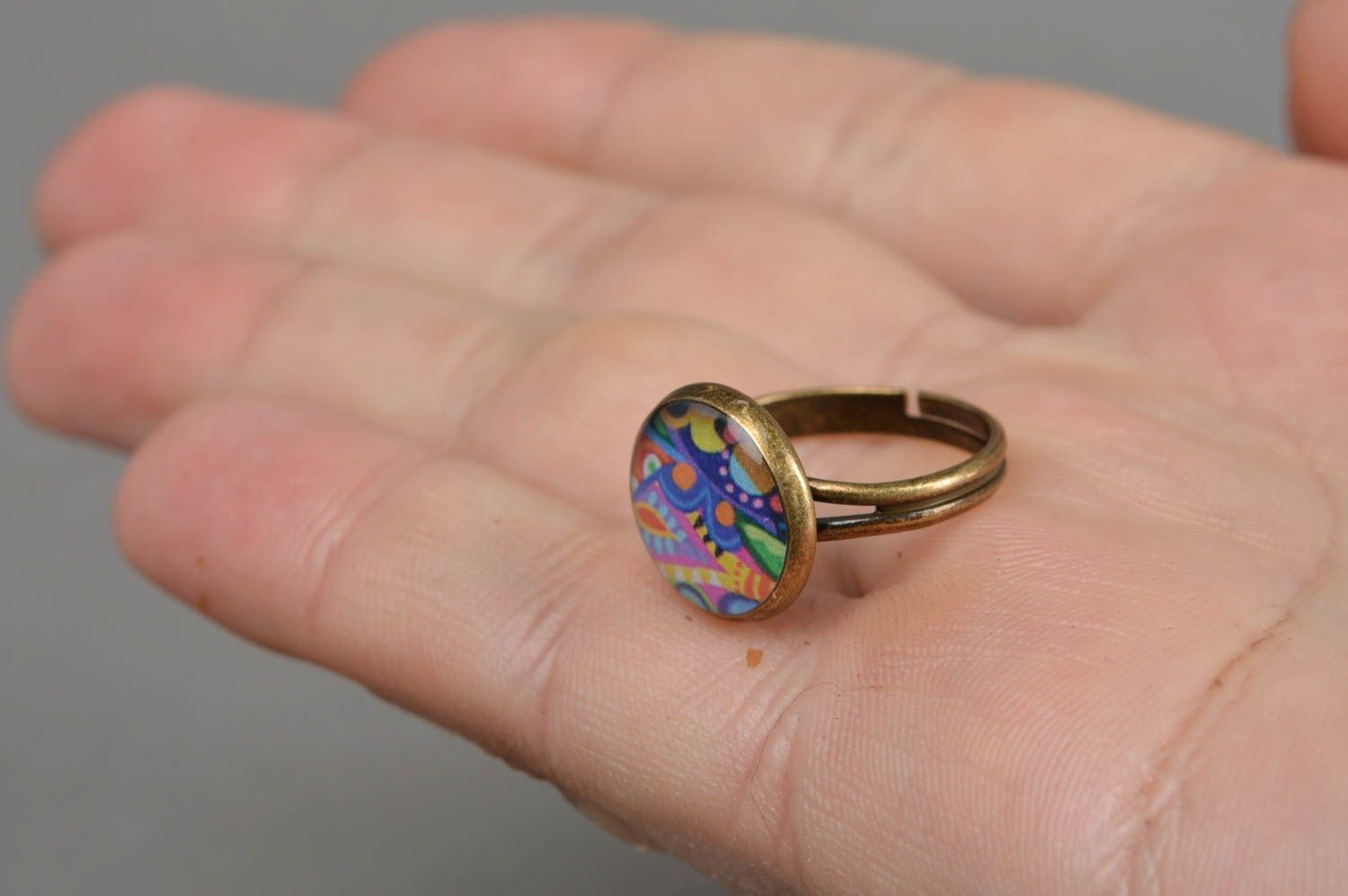 Handmade decoupage jewelry ring in epoxy resin with bright pattern on metal basis photo 4