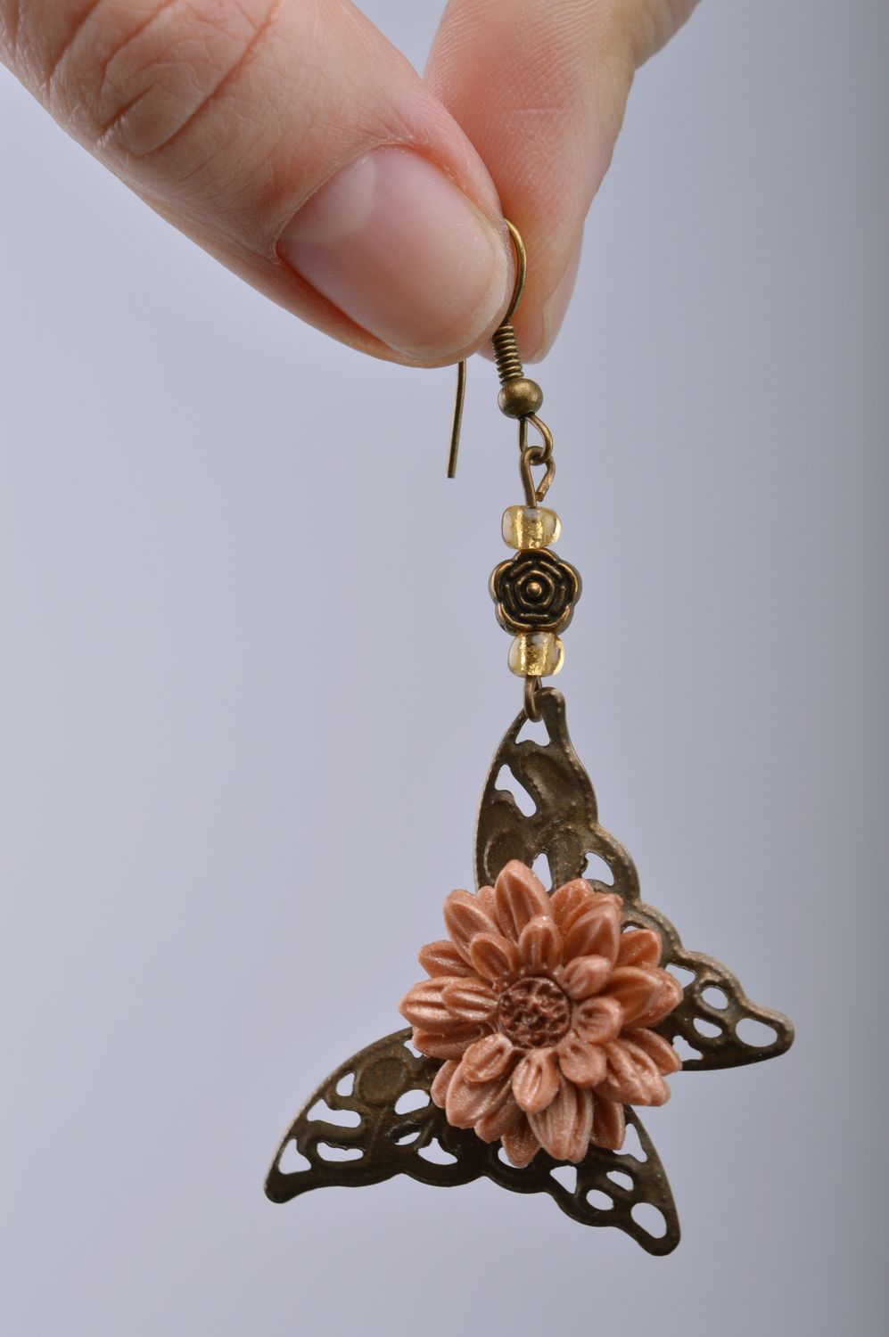 Dangle earrings hand made of metal and polymer clay in the shape of butterflies and flowers photo 2