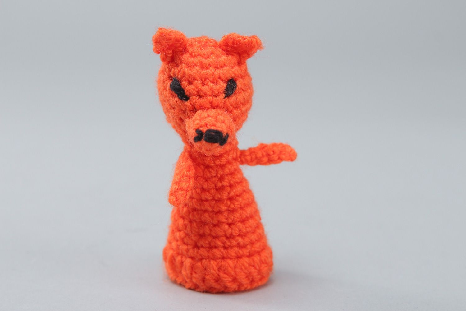 Small handmade finger puppet crocheted of acrylic threads in the shape of red fox photo 1