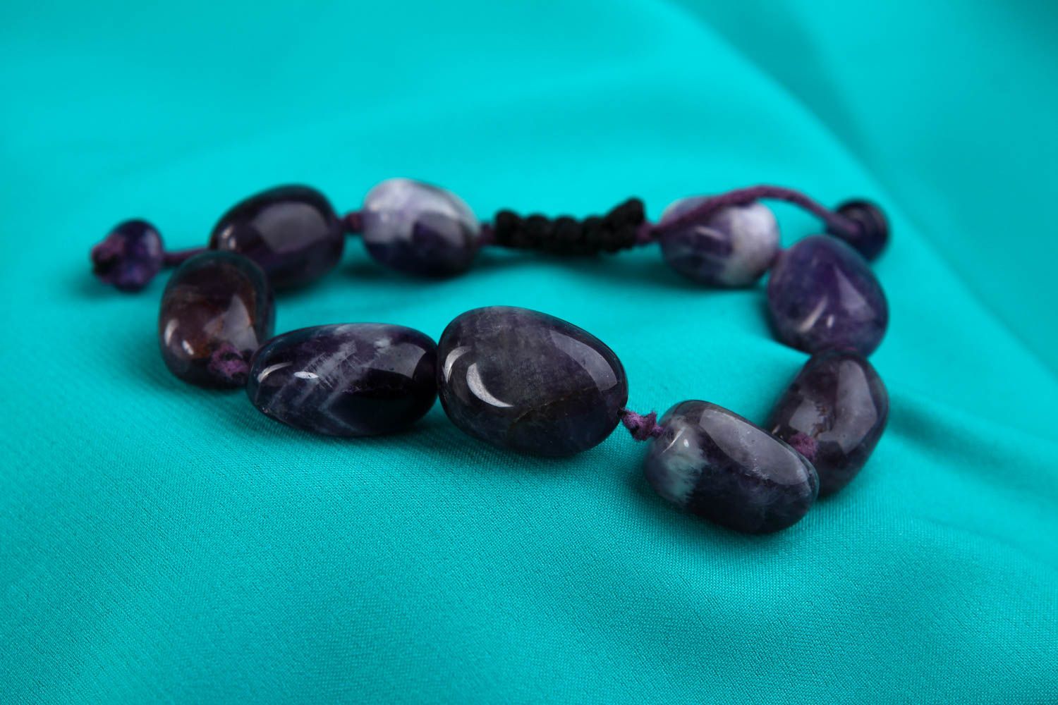 Strand bead gemstone bracelet with black cord and dark blue stone beads photo 1