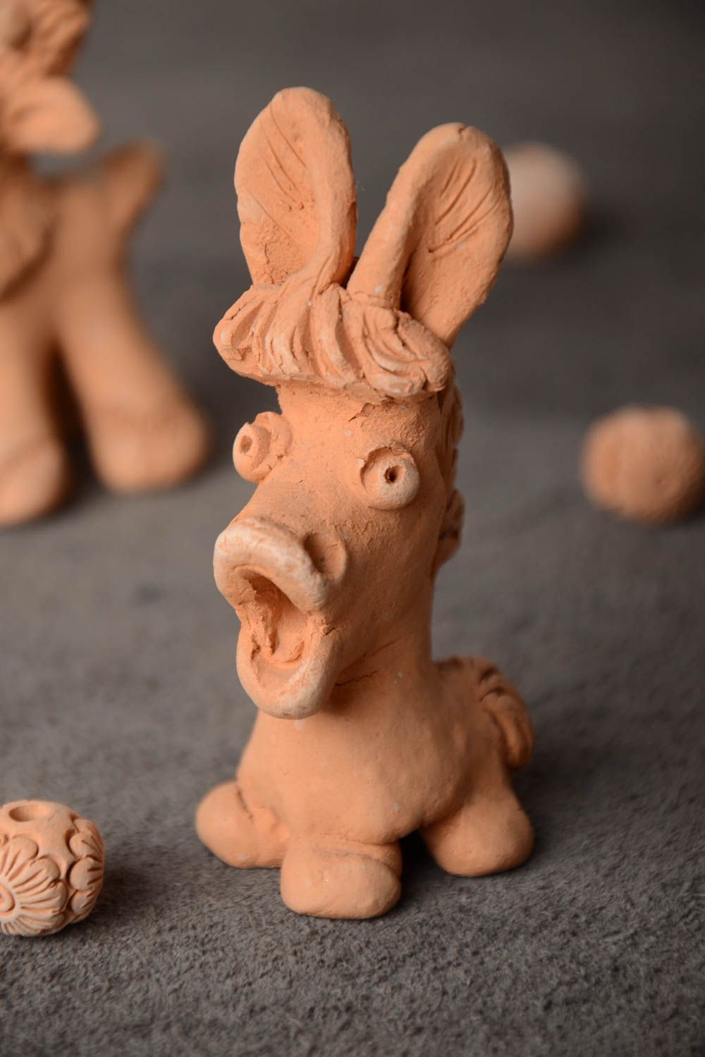 Small funny decorative ceramic souvenir figurine of donkey for interior design photo 1
