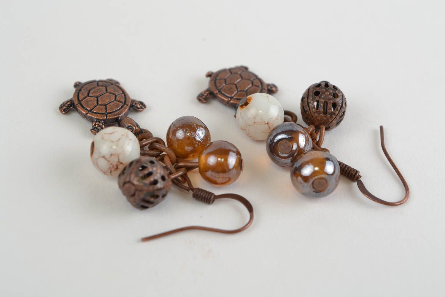 Handmade designer brown dangling earrings with glass beads and turtle charms photo 4