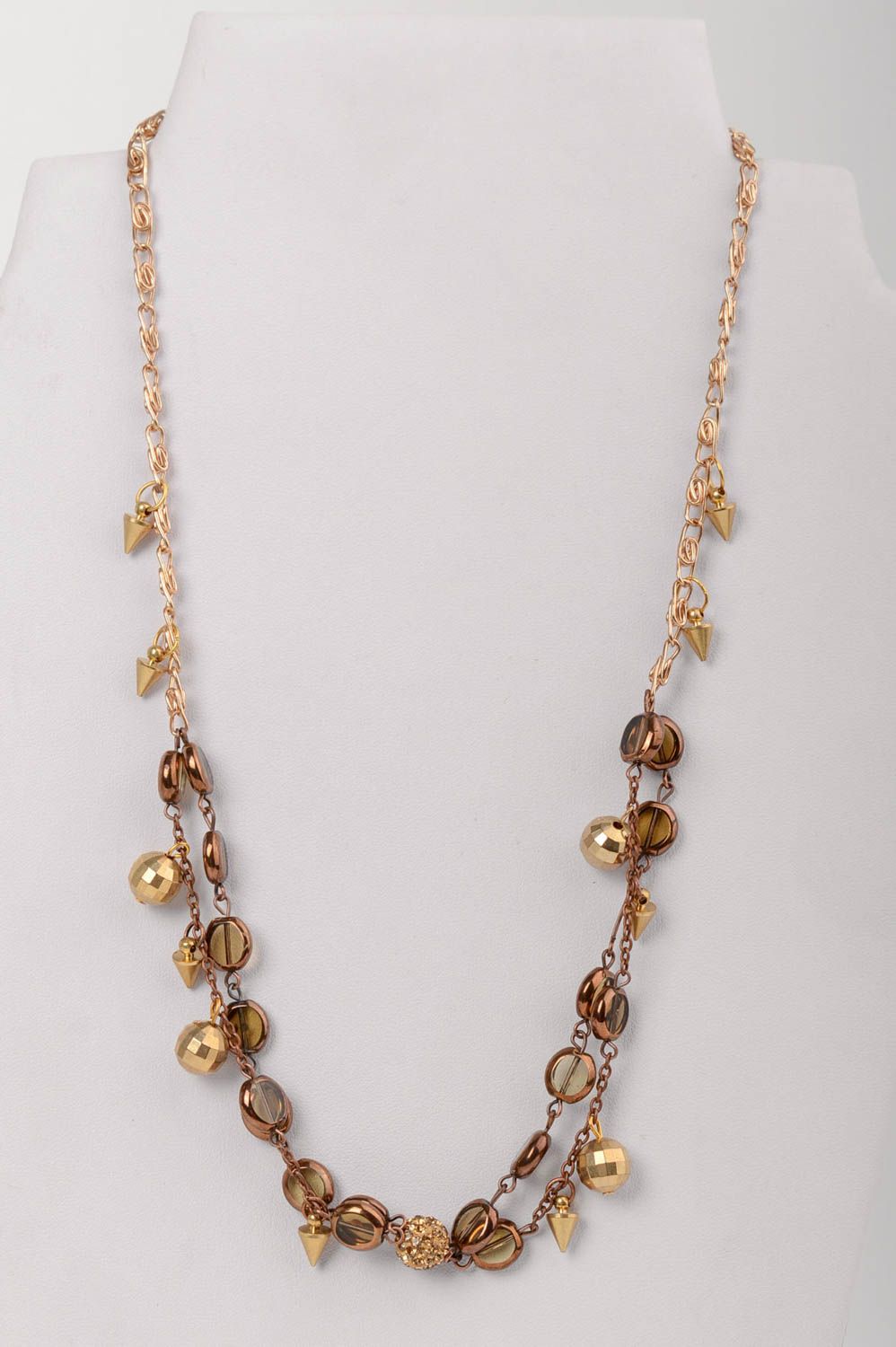 Handmade long elegant golden colored necklace with glass beads on metal chain photo 1