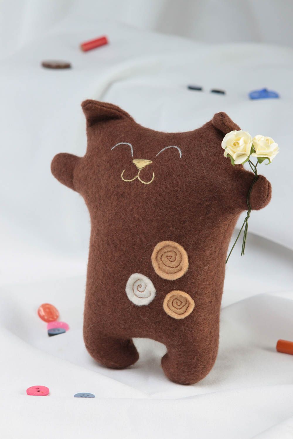Handmade brown soft small toy made of felt in shape of cat with flowers photo 1