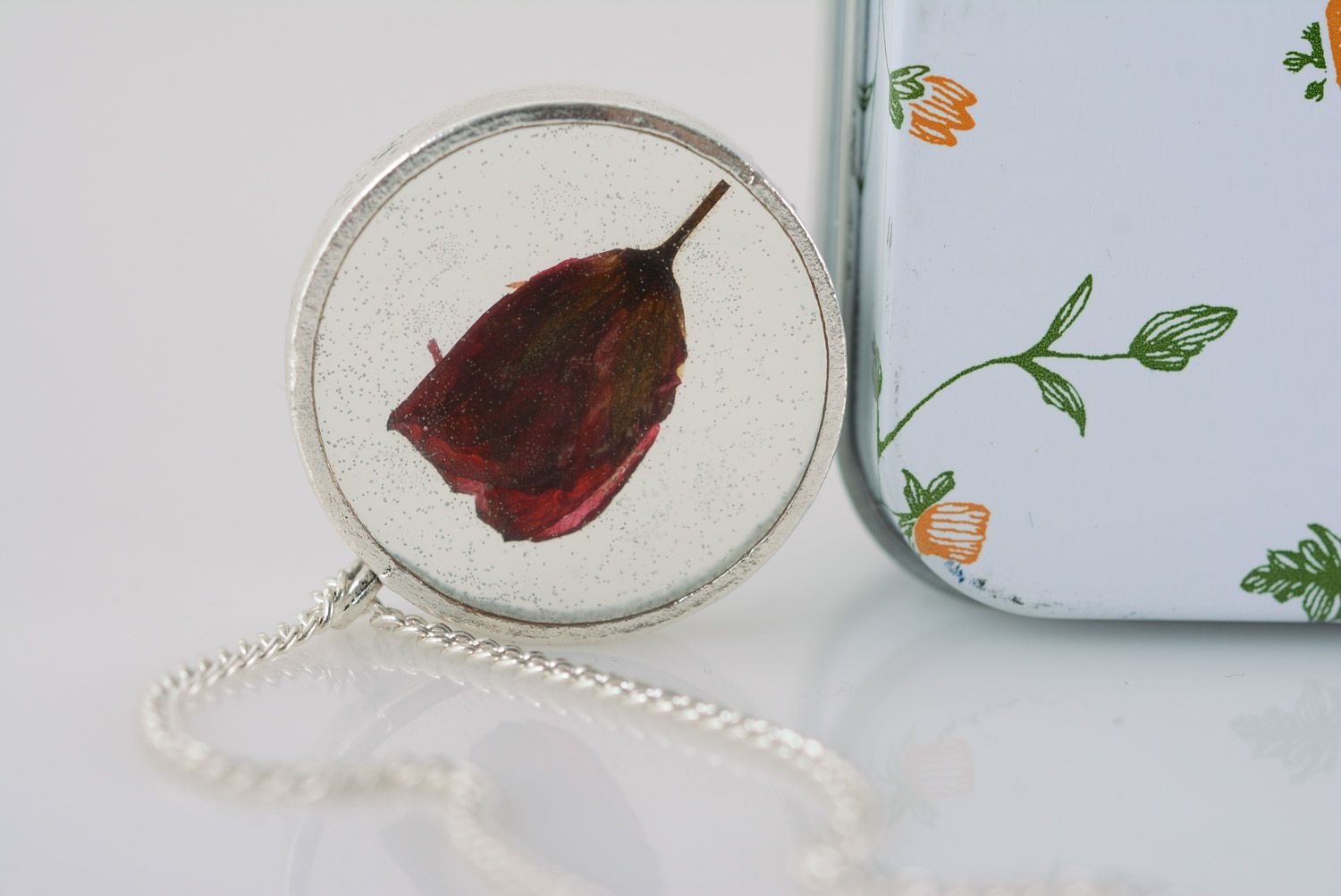 Handmade small transparent pendant with dark red flower in epoxy resin on chain photo 1
