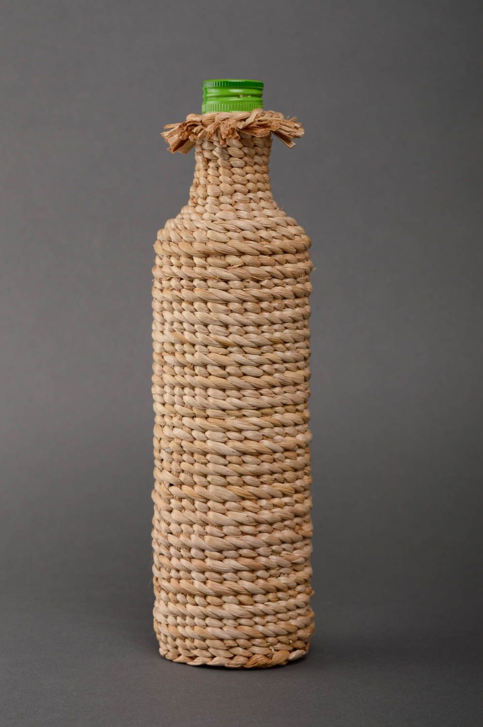Handmade bottle woven over with reedmace photo 1