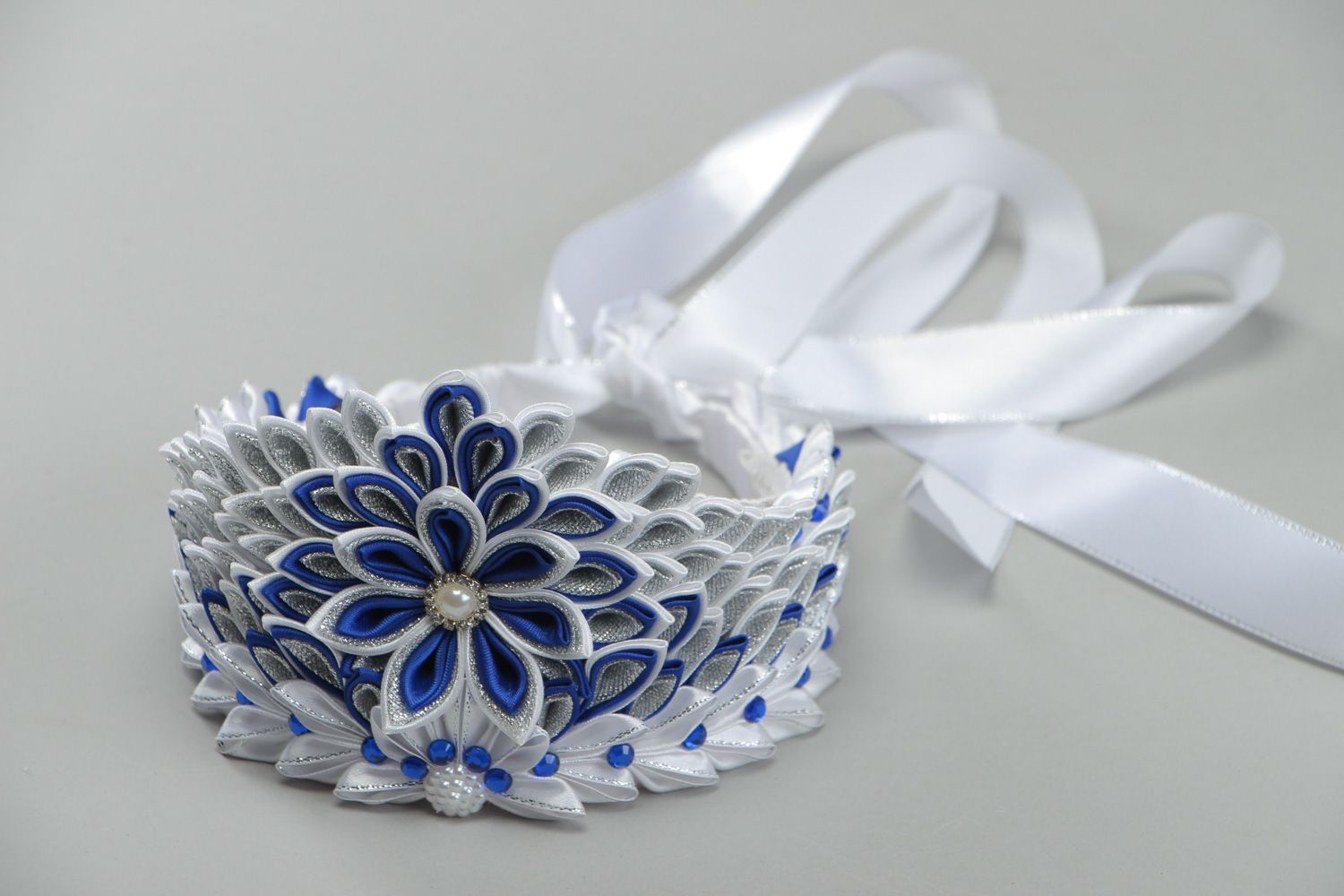 Beautiful volume handmade crown with satin ribbons in white and blue color palette photo 1