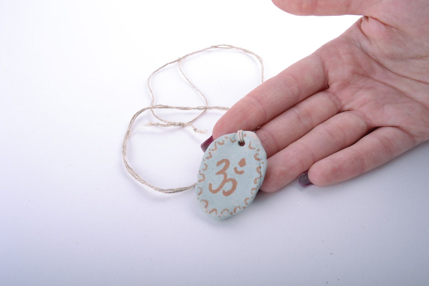 Handmade designer white clay neck pendant painted with engobes with ohm symbol photo 2