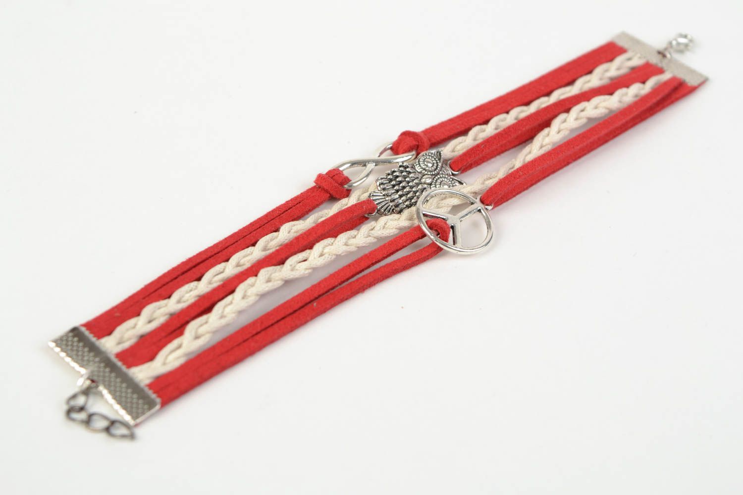Red handmade woven suede cord bracelet with inserts in the shape of various signs photo 5