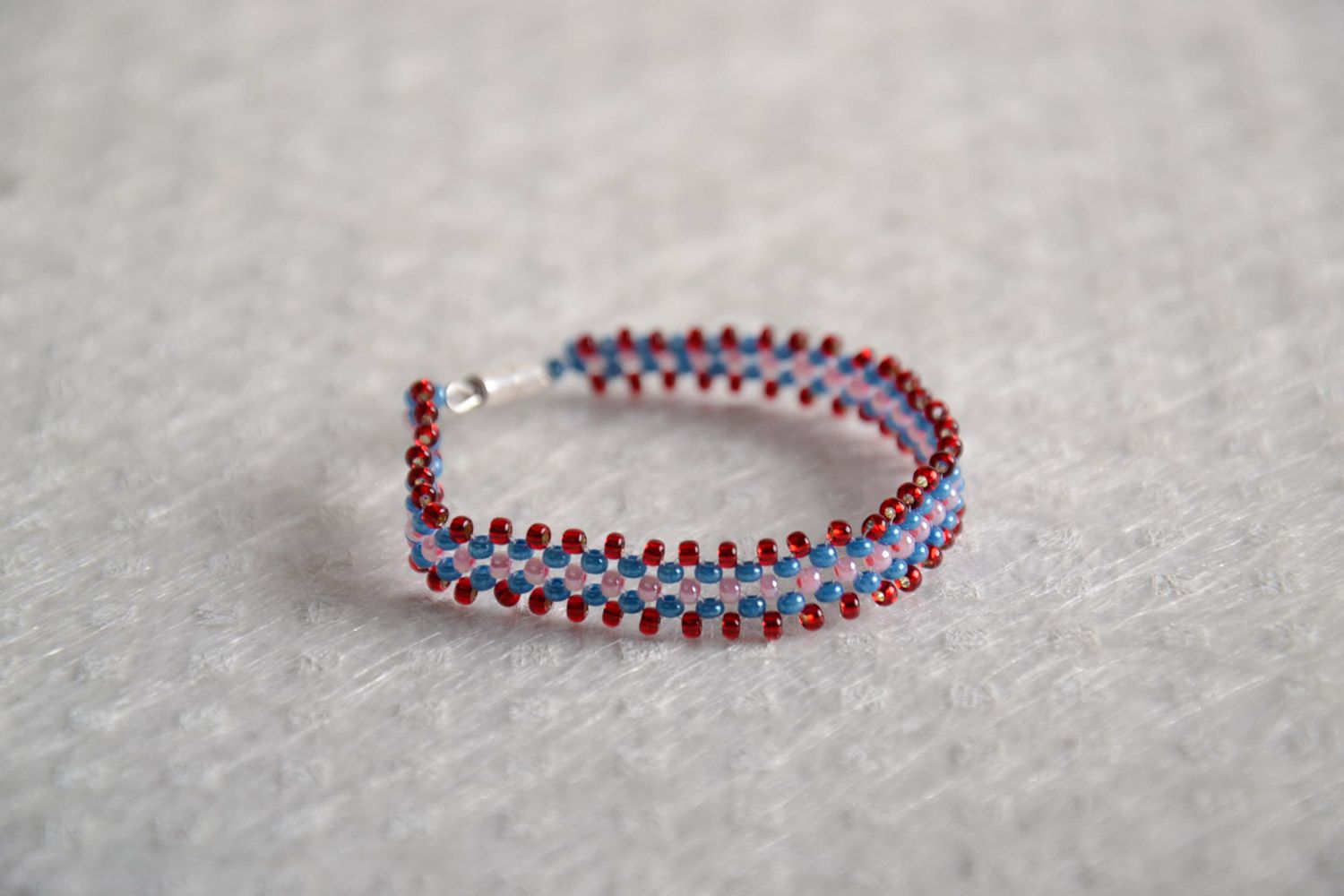 Girls' beaded bracelet made of Czech beads of red, pink, and dark blue color photo 1