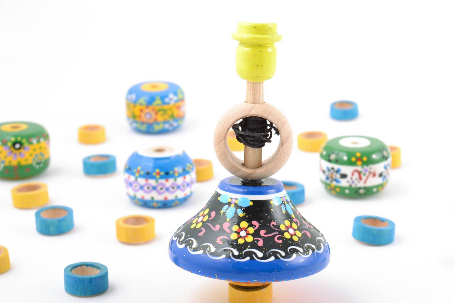 Bright colorful wooden handmade spinning top toy painted with eco dyes for kids photo 1
