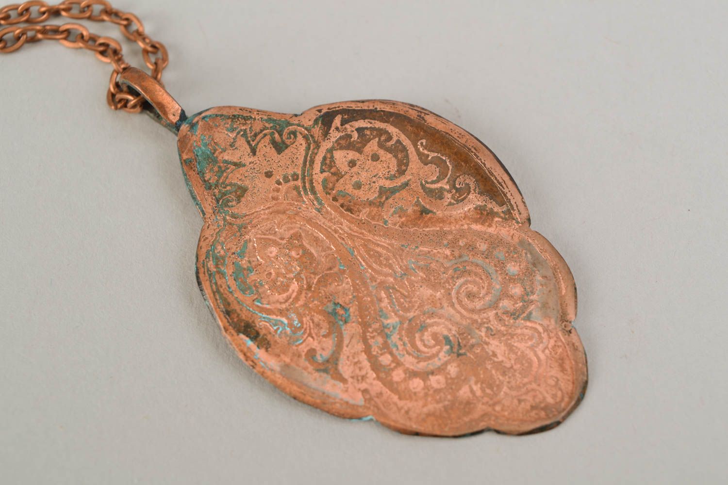 Copper pendant on long chain created using patina coating and etching techniques photo 3
