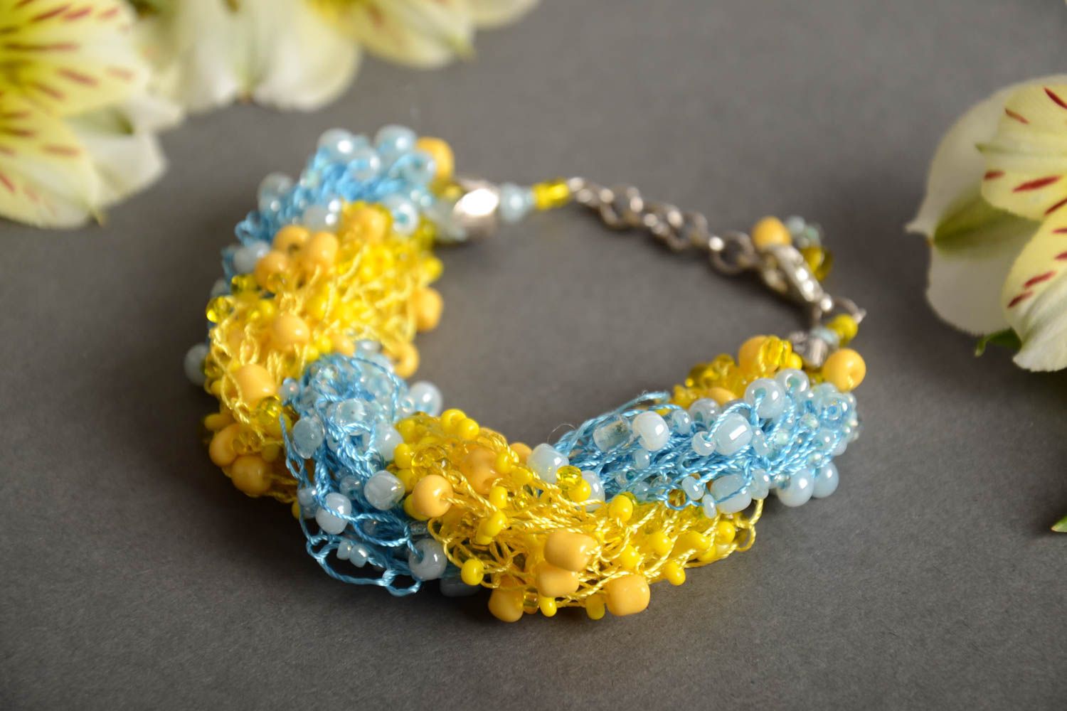 Bright handmade woven wrist bracelet crocheted of blue and yellow Czech beads photo 1