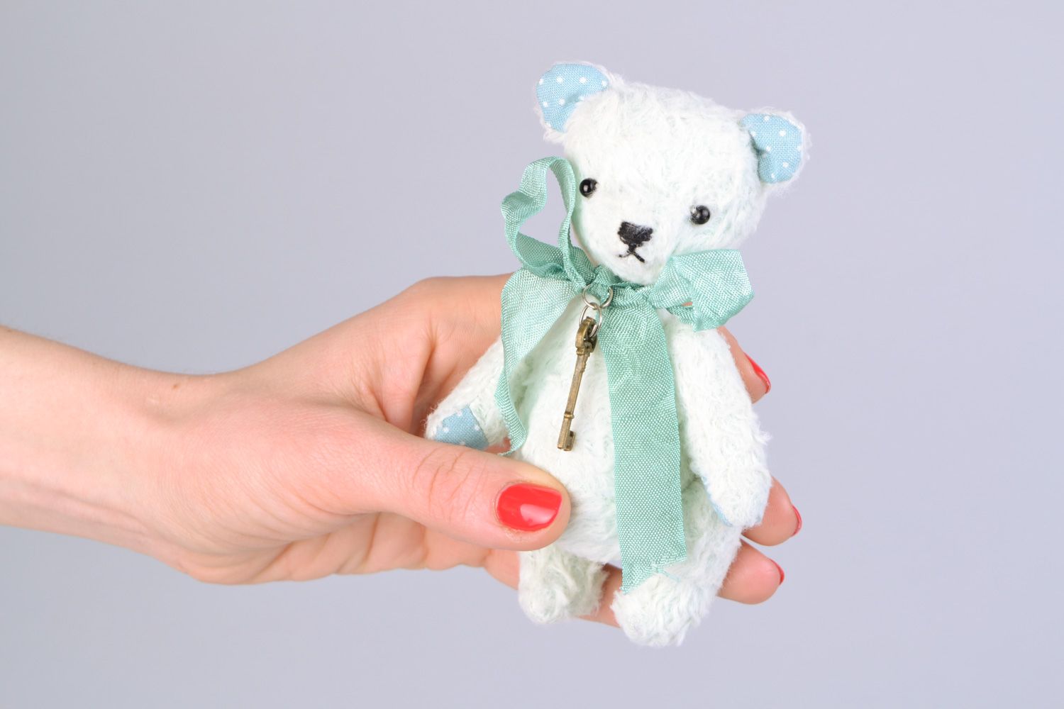 Handmade designer soft toy bear in light color palette with bow and key charm photo 2