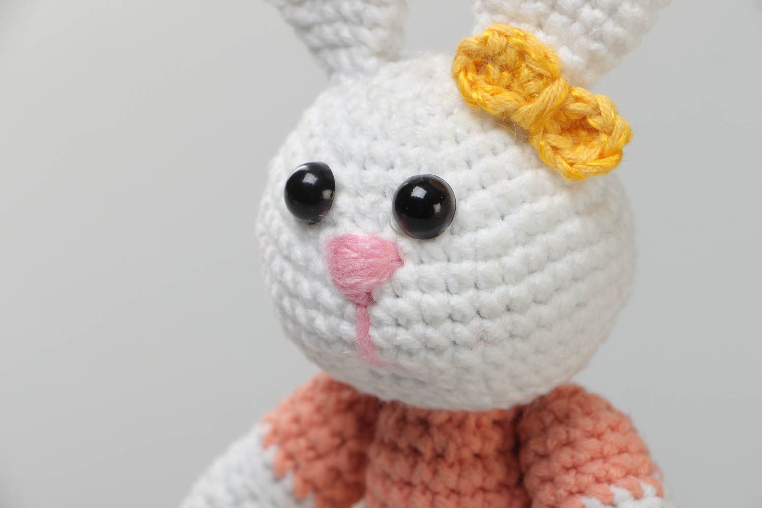 Handmade soft knitted white girl-rabbit toy in a dress for children photo 3