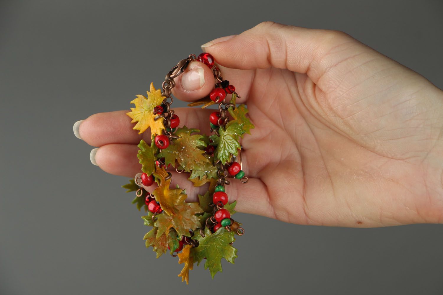Plastic bracelet with charms in the shape of leaves photo 4