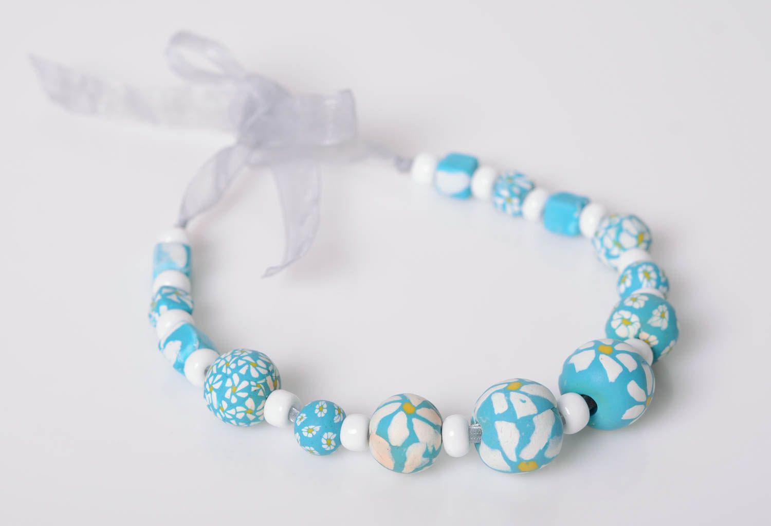 Handmade beaded necklace made of polymer clay blue with flowers on organza ribbon photo 1