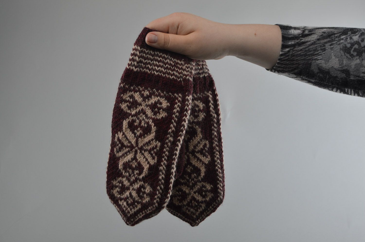 Homemade warm winter knit woolen mittens with ornaments in brown color palette photo 3