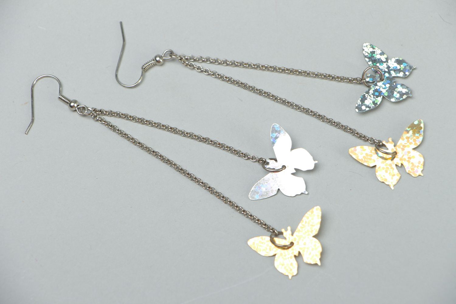 Metal earrings with charms in the shape of butterflies photo 1