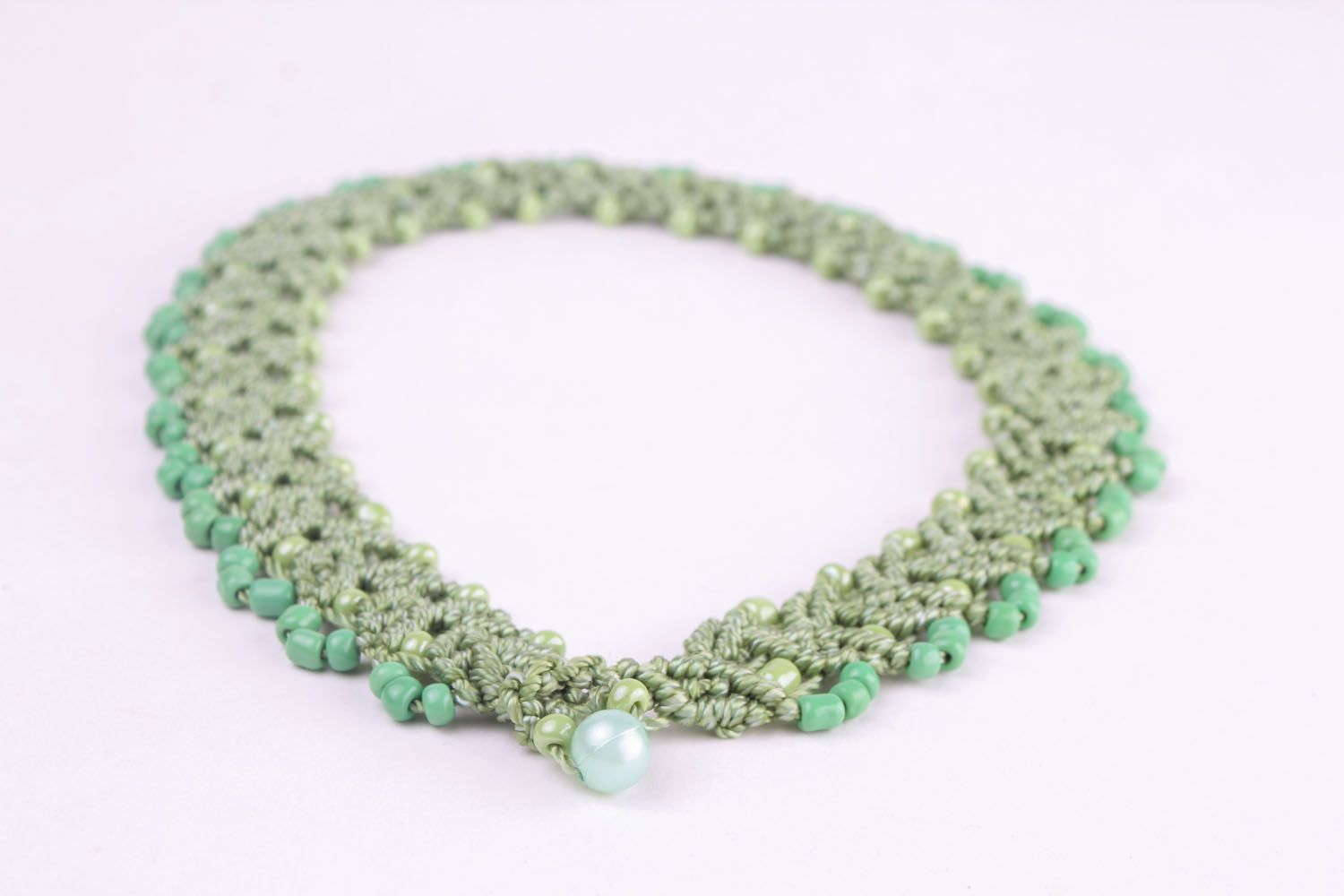 Green necklace made of threads and beads photo 3
