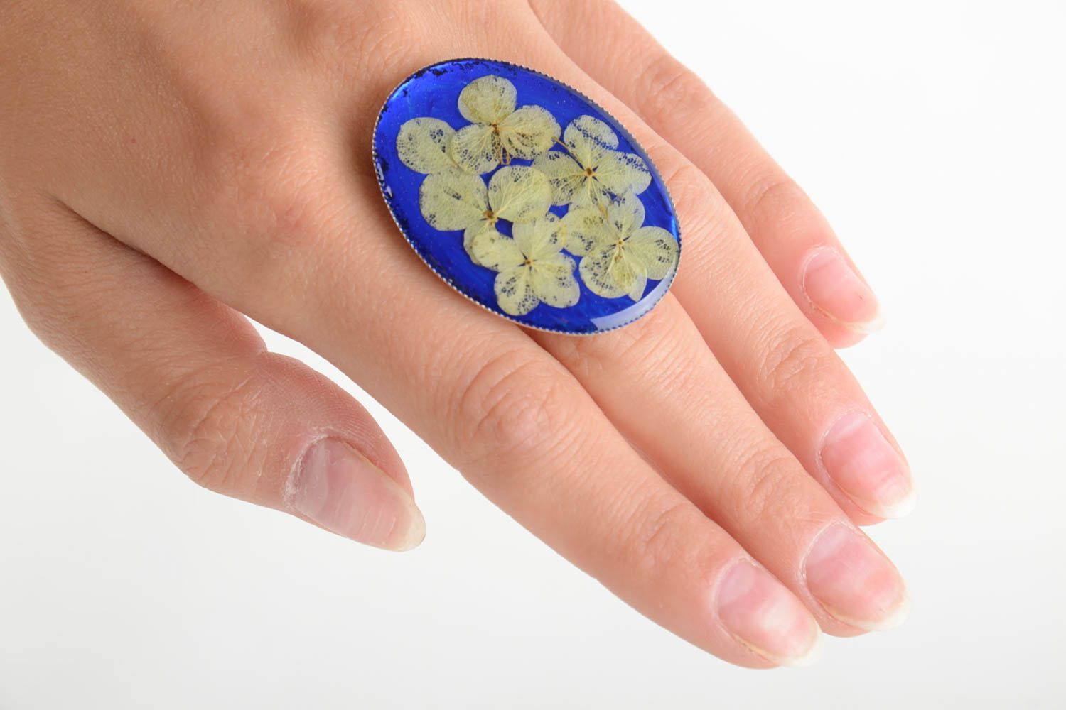 Handmade oval ring with dried flowers on bright blue basis in epoxy resin photo 5
