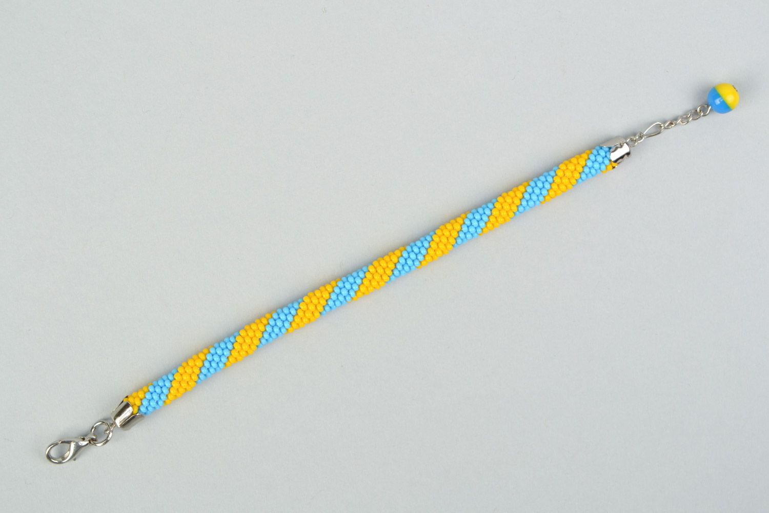 Bright handmade wrist bracelet woven of yellow and blue Czech beads  photo 5