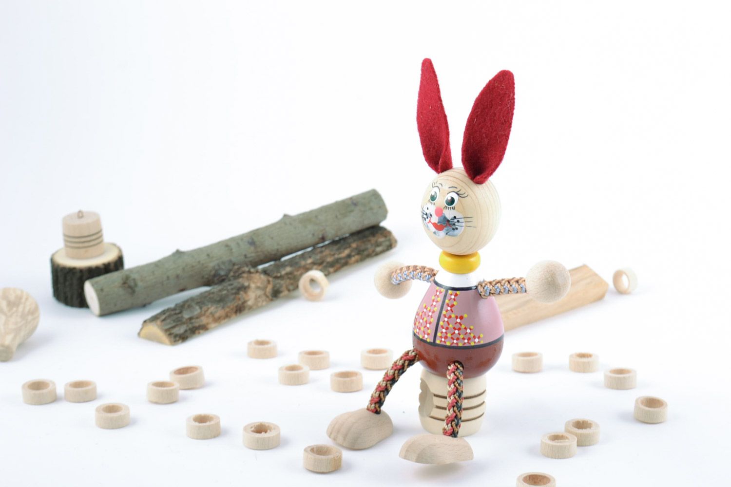 Small funny painted toy hand made of beech wood rabbit with red ears for kids photo 1