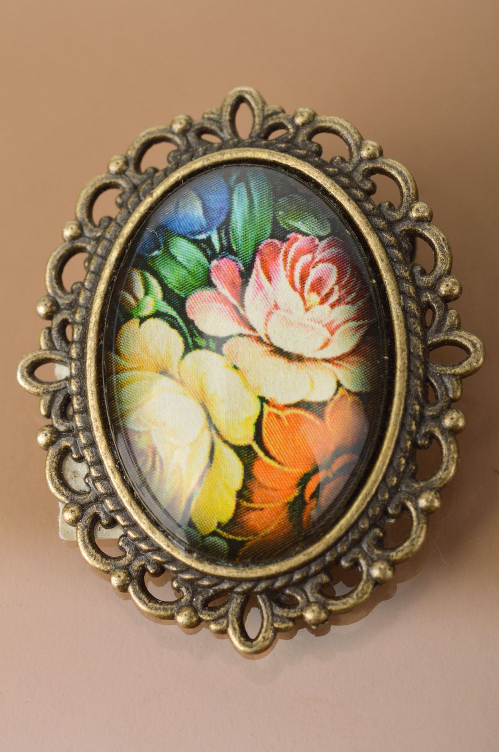 Handmade oval brooch with metal basis and floral pattern coated with glass photo 2