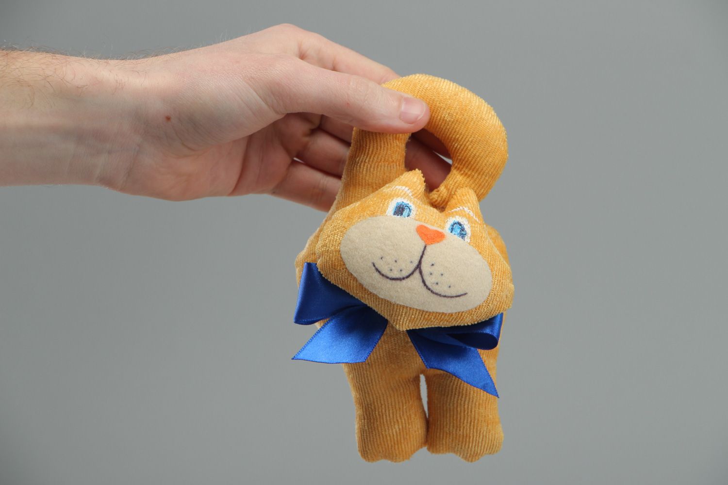 Cute handmade soft toy in the shape of yellow cat with blue bow for children photo 4