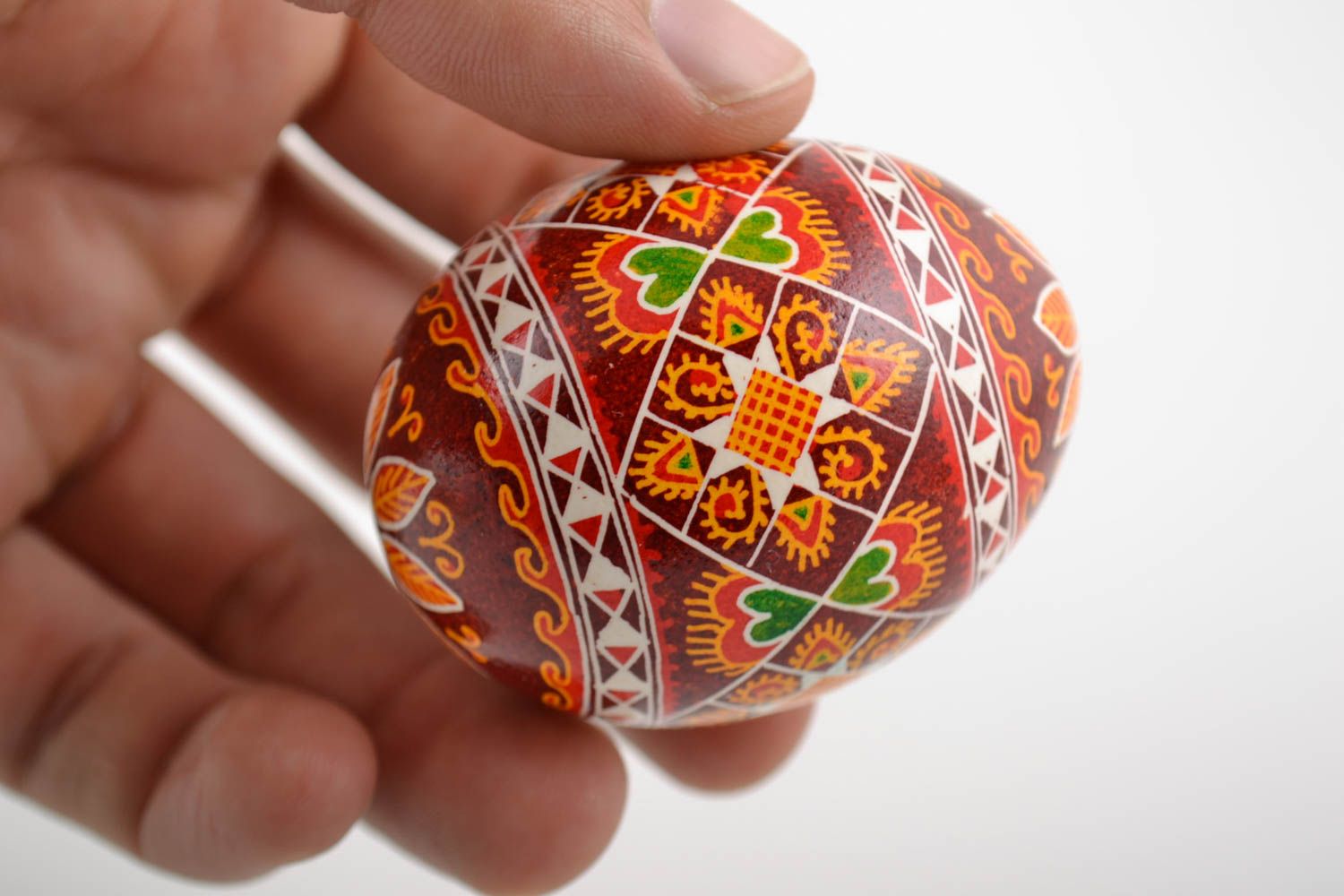Decorative handmade painted Easter egg with ornament in red color palette photo 2