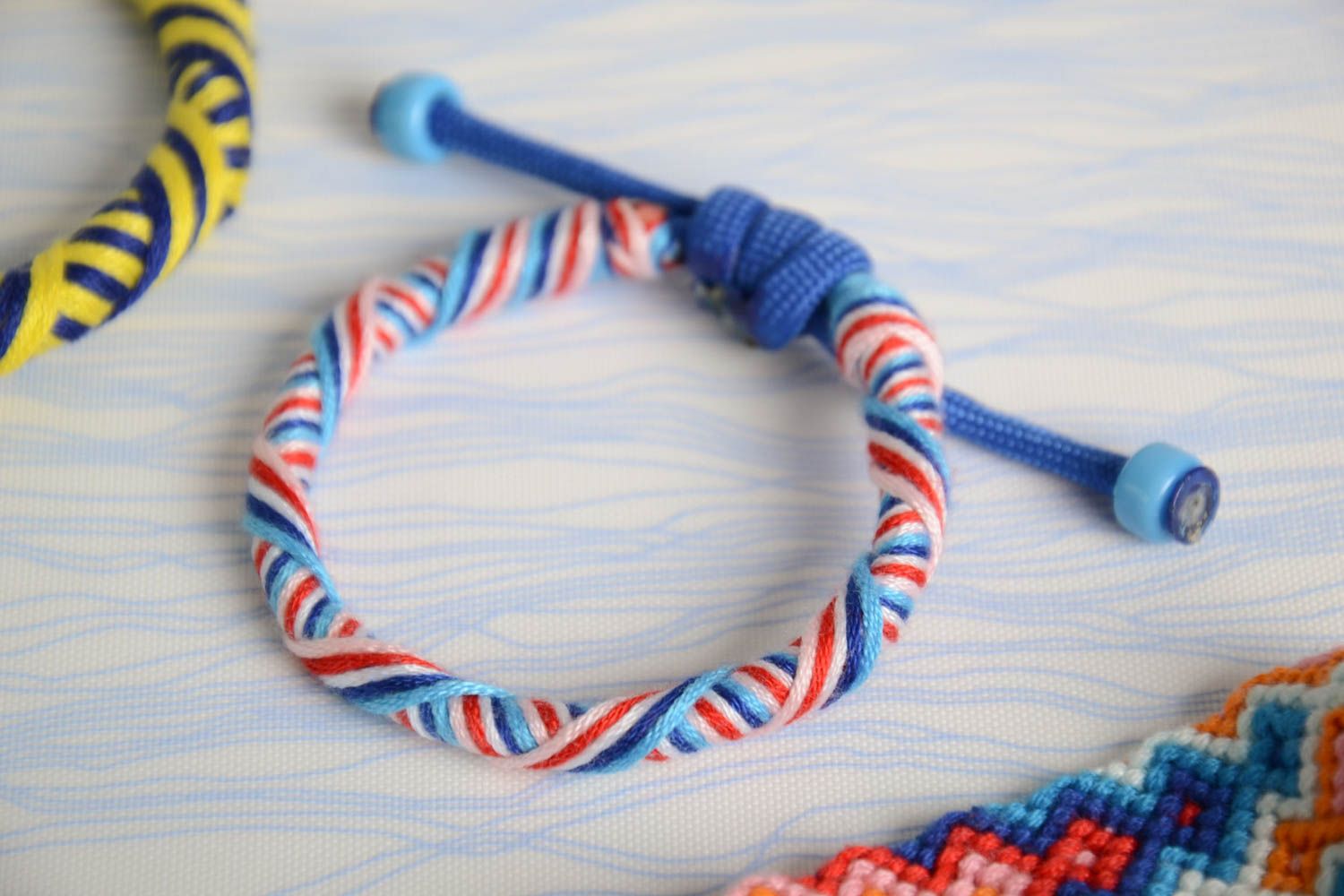 Colorful handmade bracelet made of paracord and floss thread beautiful designer accessory photo 1