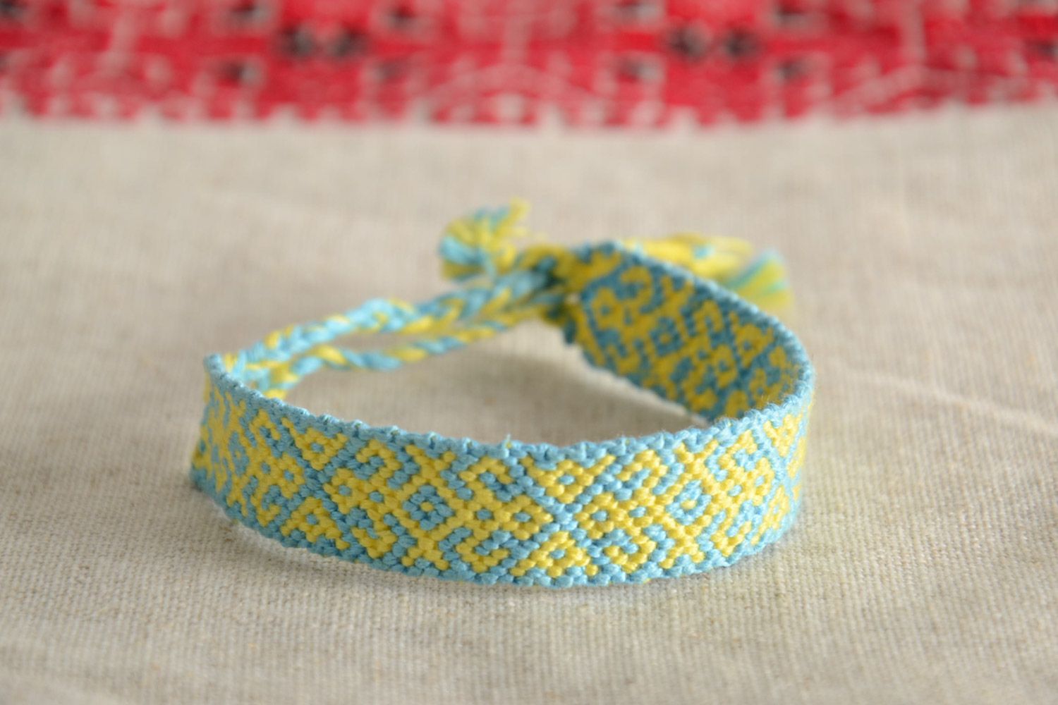 Handmade friendship wrist bracelet woven of blue and yellow threads with ties photo 1